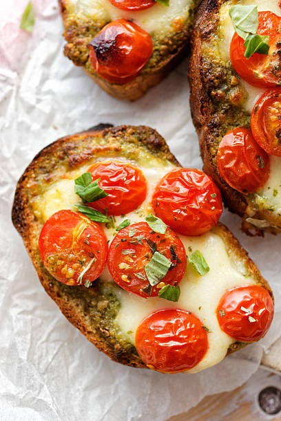 istock Bruschetta with cherry tomatoes, mozzarella cheese and herb pesto 537622192