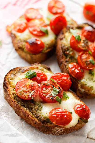 istock Bruschetta with cherry tomatoes, mozzarella cheese and herb pesto 537622338