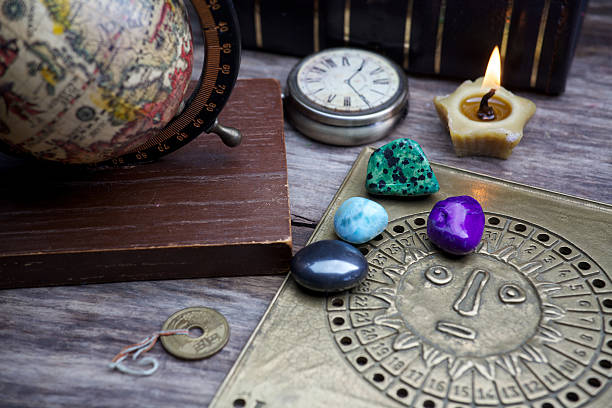 istock Ancient astrology. Old astrology globe and books with lighting candle 537624466