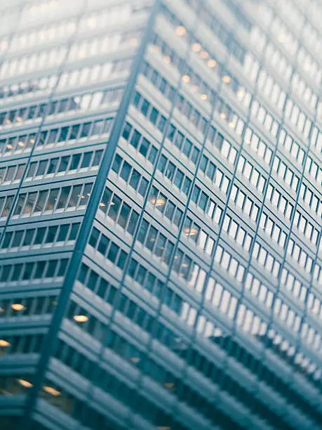 Photo of Toned and blurred modern city building from below