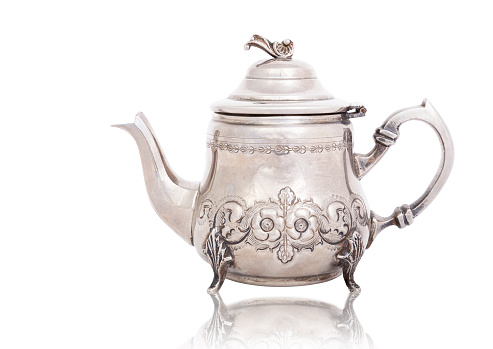 Beautiful shiny teapot on the white background.