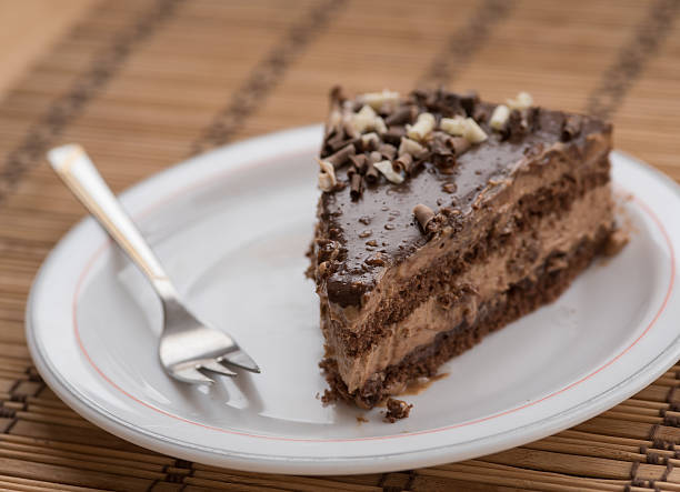 istock Slice of chocolate cake  garnished with nuts 537628144