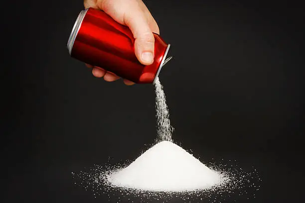 Unhealthy food concept - sugar in carbonated drinks. High amount of sugar in beverages