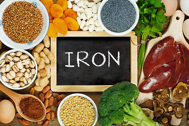 Iron rich foods Collection iron rich foods as liver, buckwheat, eggs, parsley leaves, dried apricots, cocoa, lentil, bean, blue poppy seed, broccoli, dried mushrooms, peanuts and pistachios on wooden table. mallow family stock pictures, royalty-free photos & images