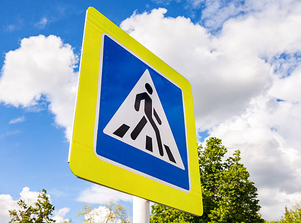 istock Road sign pedestrian crossing with clouds in background 537629350