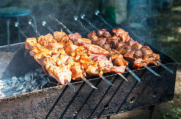 istock Appetizing hot shish kebab on metal skewers 537629498