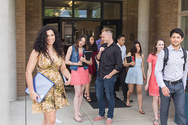 istock Diverse group of university students hanging out together at school 537629986