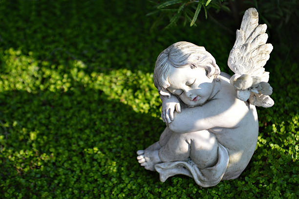 A Figurine of Cute Sleeping Angel Who put his hand under head, Isolated on White Background.