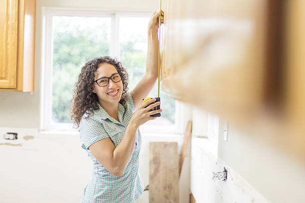 istock Young female homeowner working on diy project at home 537630274