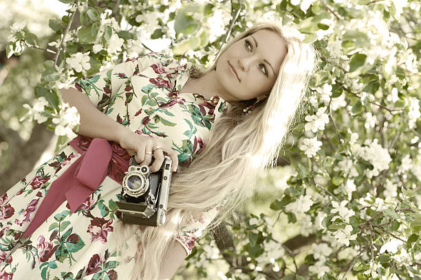 istock Woman with a retro camera 537630296