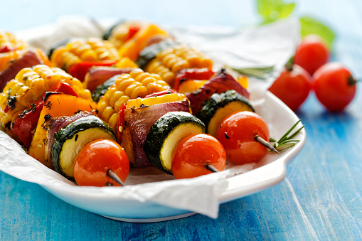Vegetarian skewers with organic vegetables on a white plate