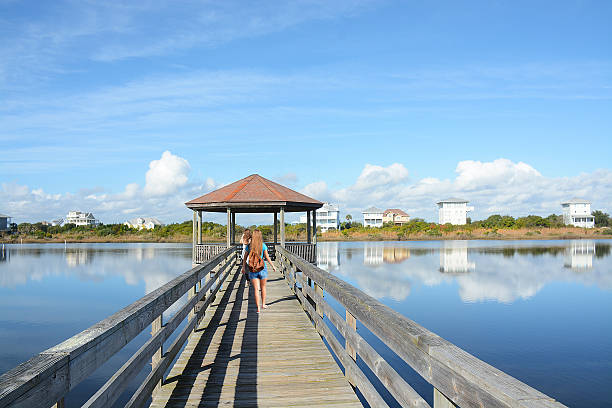 istock Girl walking on a pier. 537631074