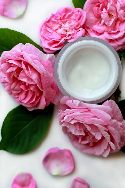 istock open cosmetic face cream and roses, flat lay composition 537632698