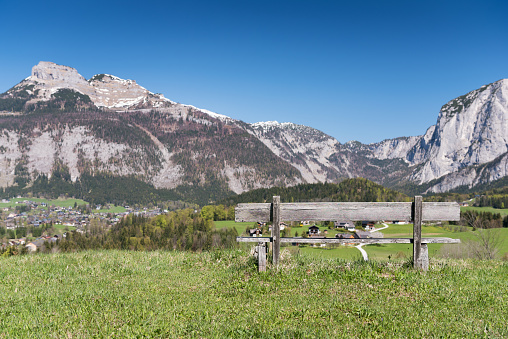 A wooden bench in a Nature Reserve with a beautiful view over the Mountains Loser and Trisselwand in the middle of the Austrian Alps. Nikon D810 Polarizer. Converted from RAW.
