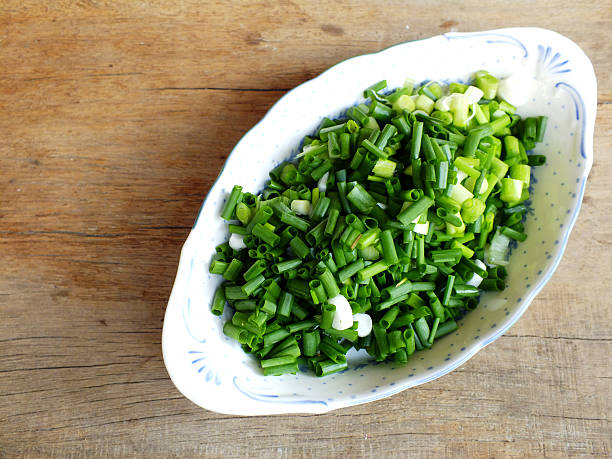 istock fresh spring onion chopped green onions on wooden background 537637896