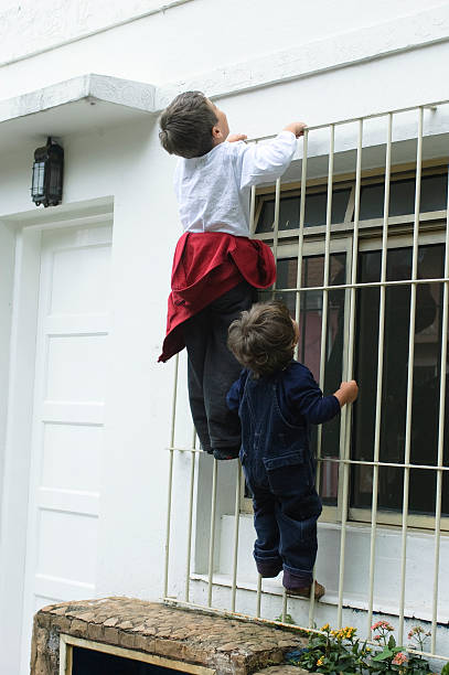 istock Children playing up in the window. 537640687