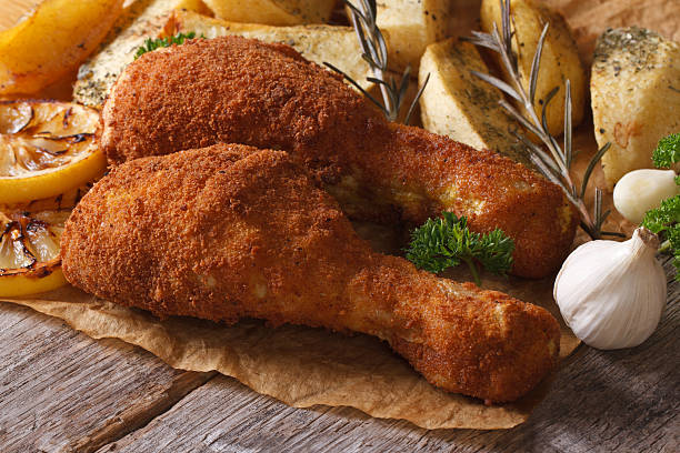 istock fried chicken leg in batter with potatoes 537641329