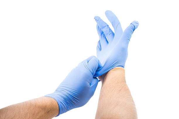 istock Male Putting On Latex Gloves 537641559