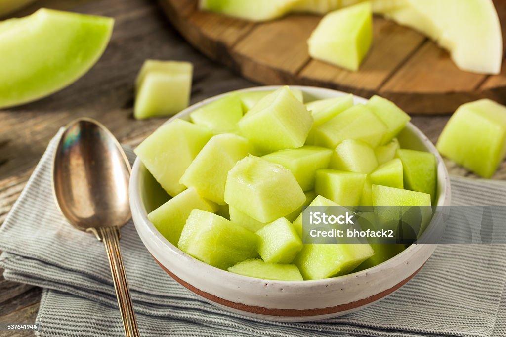 Green Organic Honeydew Melon Green Organic Honeydew Melon Cut in a Bowl Bright Stock Photo