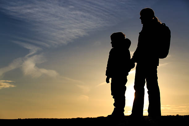 istock mother and son travel at sunset 537643024