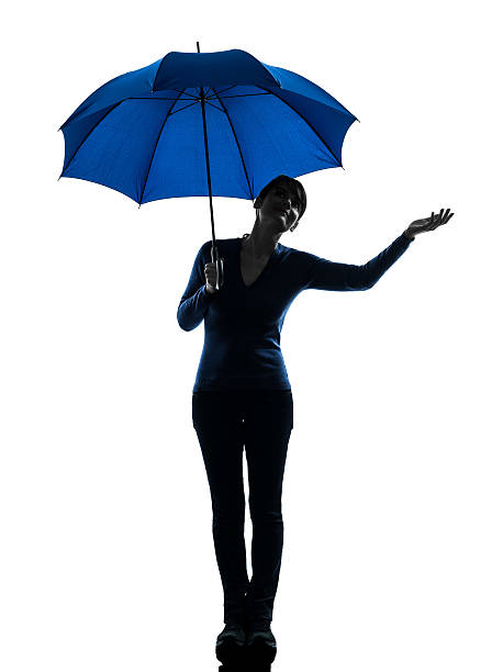 istock woman holding umbrella palm gesture silhouette 537643443