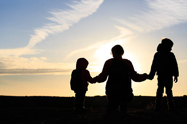istock father and two kids travel at sunset 537643954