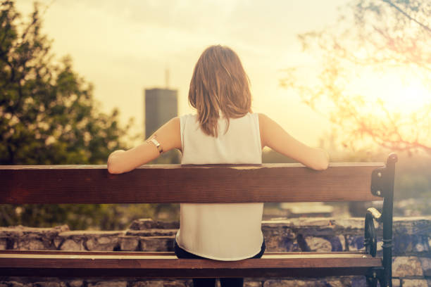 istock Girl enjoying city view from a bench. 537644384