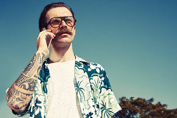 Hipster youngmen using smartphone at park.