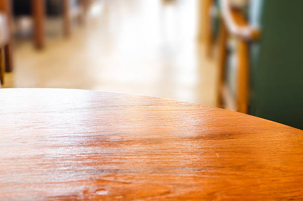 istock wooden circle table top and blur cafe background 537644807