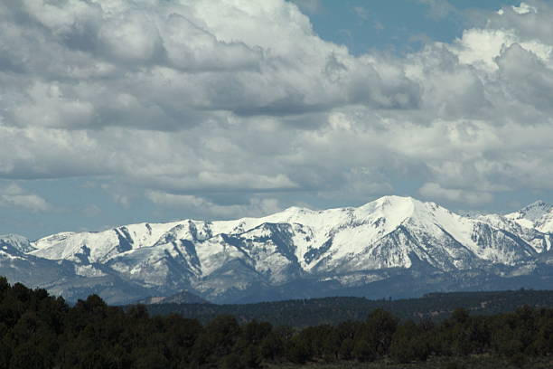 istock Sunlit, snowcapped mountains, under stormy sky 537645118