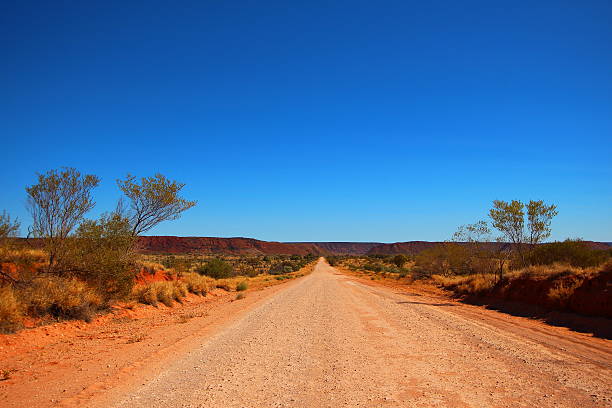 Dusty outback road, Australia Unpaved road through Australian outback. outback stock pictures, royalty-free photos & images