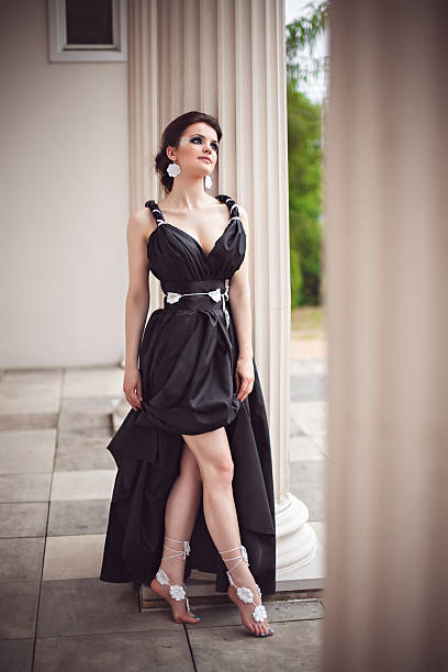 istock Sensual girl in long black dress at column 537645520
