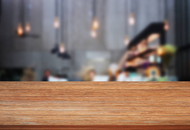 istock Top wooden table with blurred cafe background 537645534