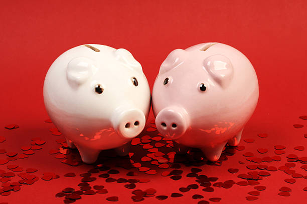 istock Two fallen in love piggies bank on red background 537646027