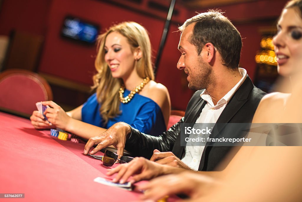 Friends playing at poker at Casino 20-29 Years Stock Photo