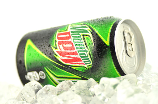 Kwidzyn, Poland - March 15, 2014: Can of Mountain Dew drink isolated on white. Mountain Dew citrus-flavored soft drink produced by PepsiCo. Mountain Dew was introduced in 1940
