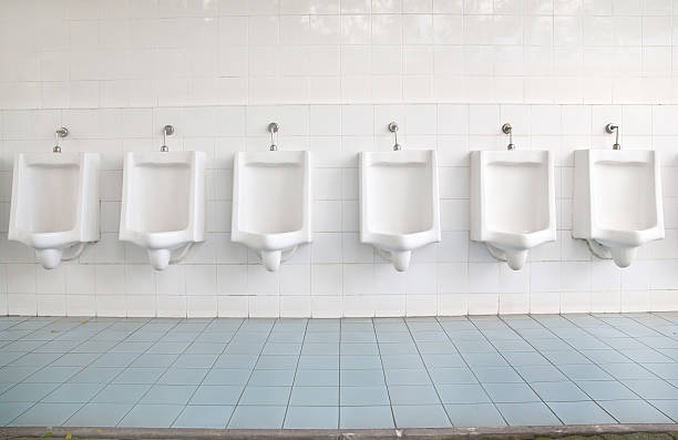 istock Urinals in tiled wall in a public restroom 537663807