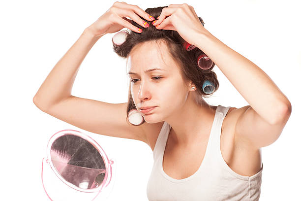 istock Bored young woman without make-up, adjusted curlers 537664779