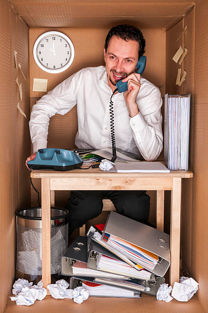 office in a box businessman working in an office in a box - concept small office constricted stock pictures, royalty-free photos & images