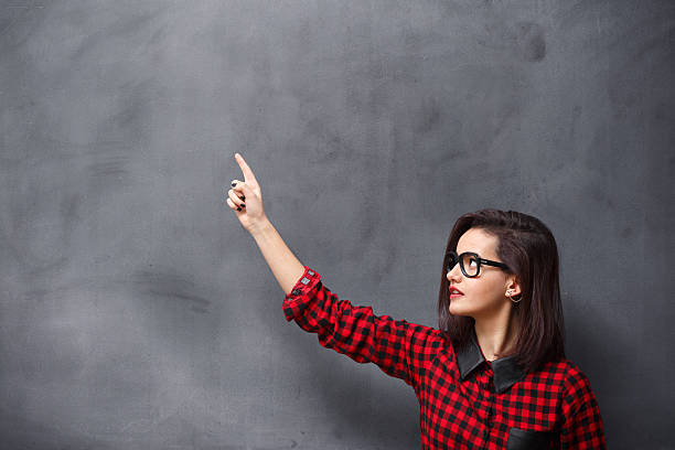 istock Young woman pointing on blackboard 537666097