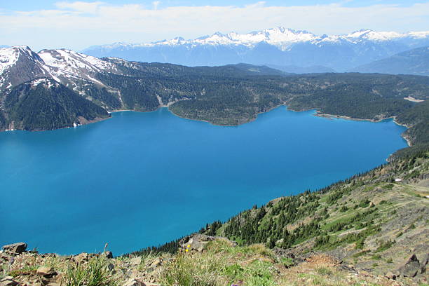 istock Beautiful lake with snow covered mountains in the background 537667399