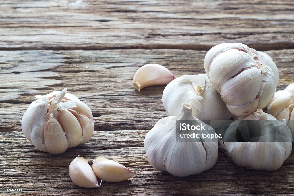 Garlic on the wooden background Garlic Stock Photo