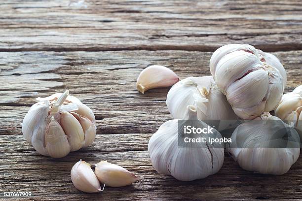 Garlic On The Wooden Background Stock Photo - Download Image Now - Garlic, 2015, Clove - Spice