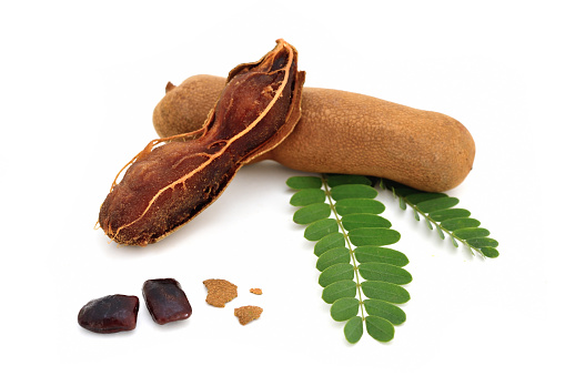 Tamarind and leaves on isolated white background