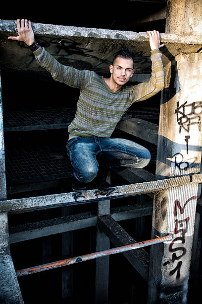 istock Handsome smiling young man in abandoned industrial site 537673073