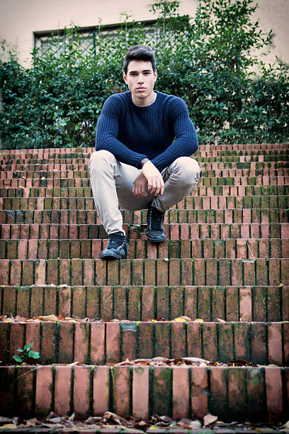 istock Handsome young man sitting outdoor on old brick stairs 537673083