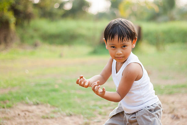 istock happy young asia boy  playing kungfu having fun 537673659