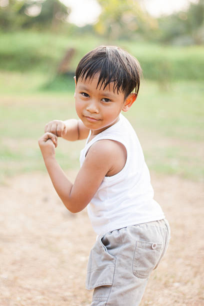 istock happy young asia boy  playing kungfu having fun 537675259