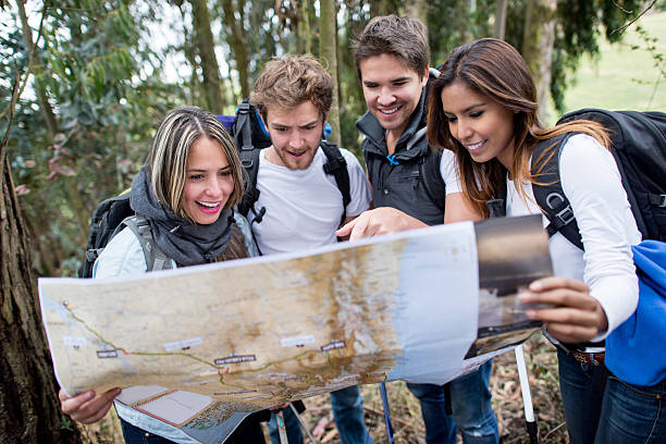 istock Group of hikers holding a map and finding their way 537675305