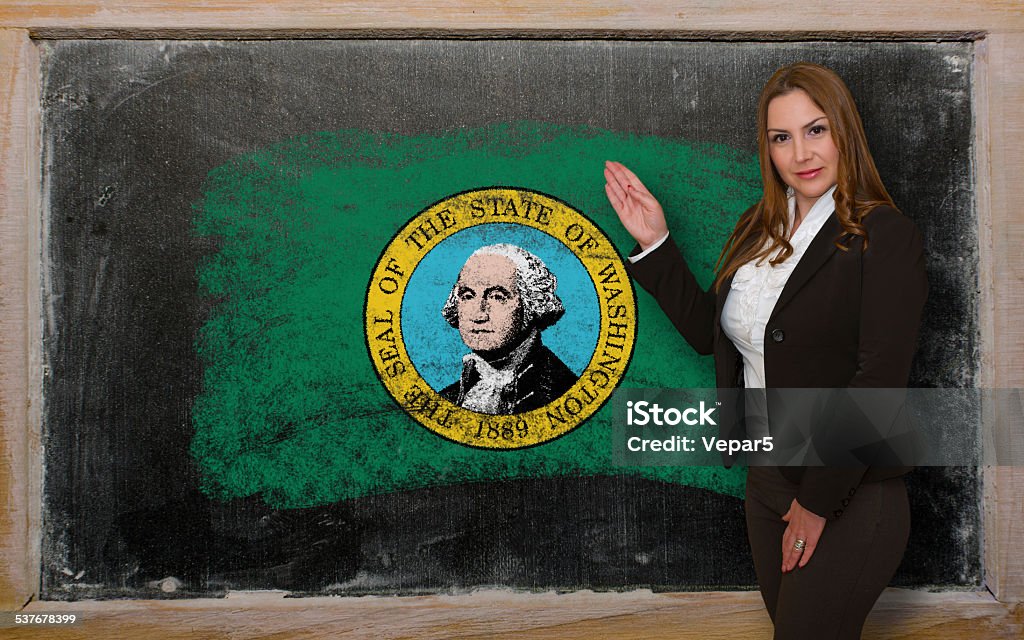 Teacher showing flag of washington on blackboard for presentation Successful, beautiful and confident woman showing flag of washington on blackboard for marketing research, presentation and tourist advertising 2015 Stock Photo